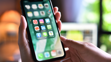 Social media apps on a phone in a woman's hand