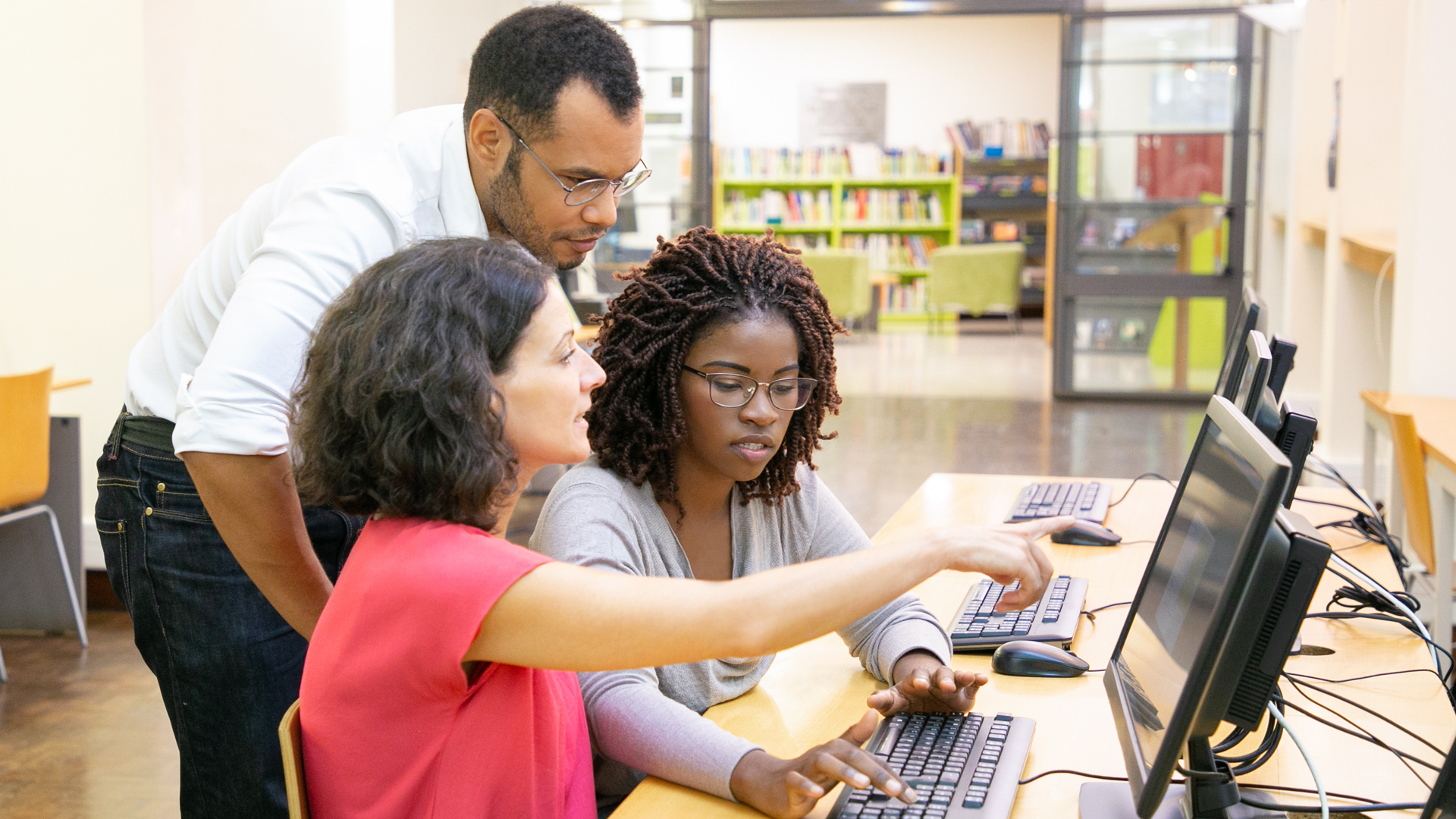 instructor-helping-students-computer-class